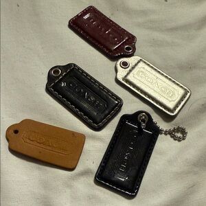 Coach Leather bag tag Collection in Black, Tan, Silver, and Burgundy